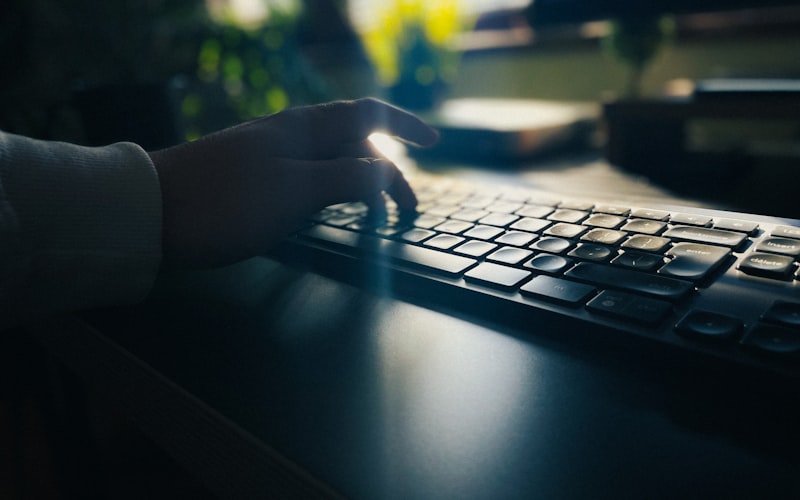 Person typing on a keyboard